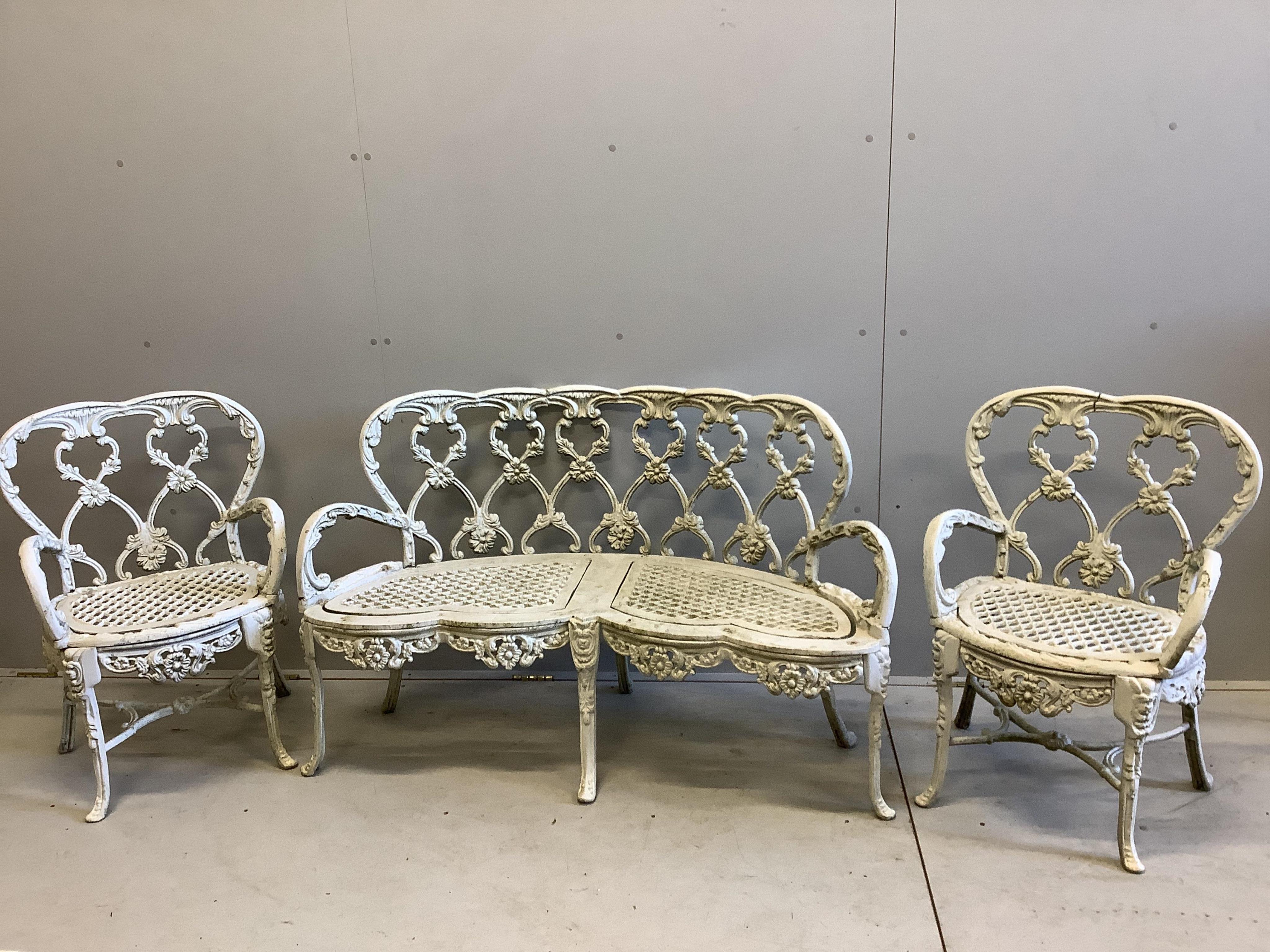 A Victorian style white painted cast aluminium three piece garden suite, bench width 126cm, depth 50cm, height 78cm and a two similar circular topped garden tables. Condition - fair